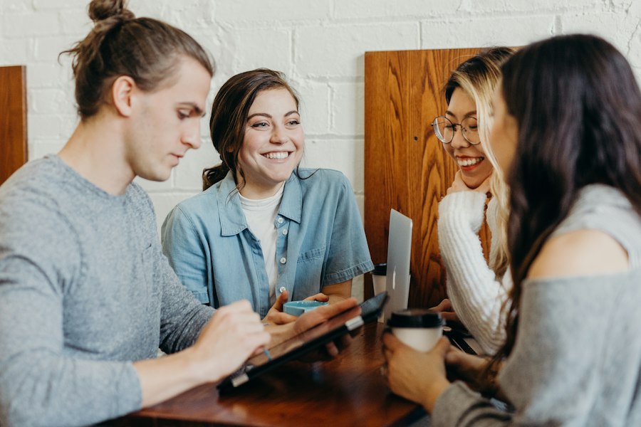 Students smiling around a table