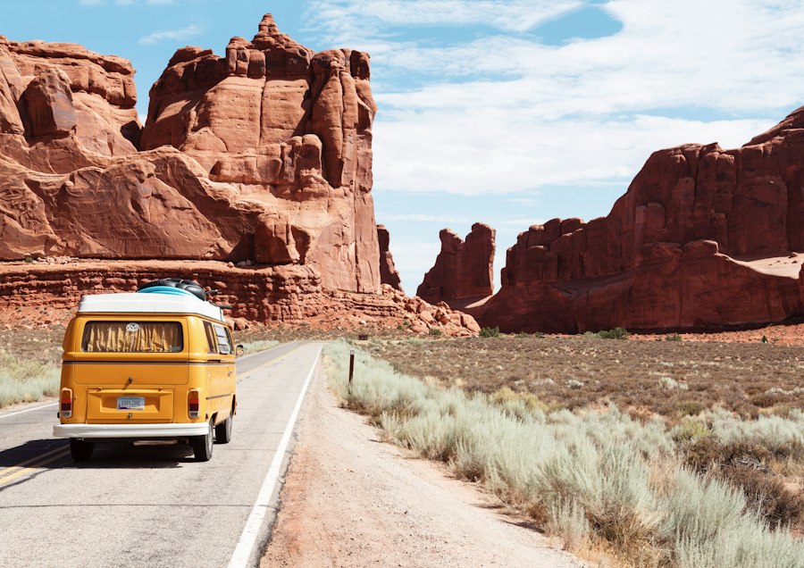 A yellow van on a desert road