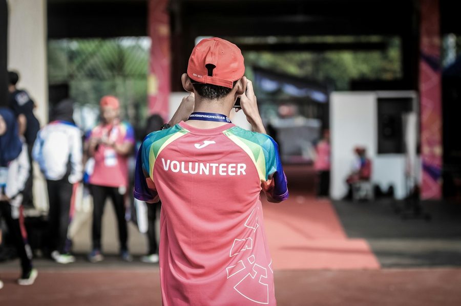 A volunteer taking a photo at a community event